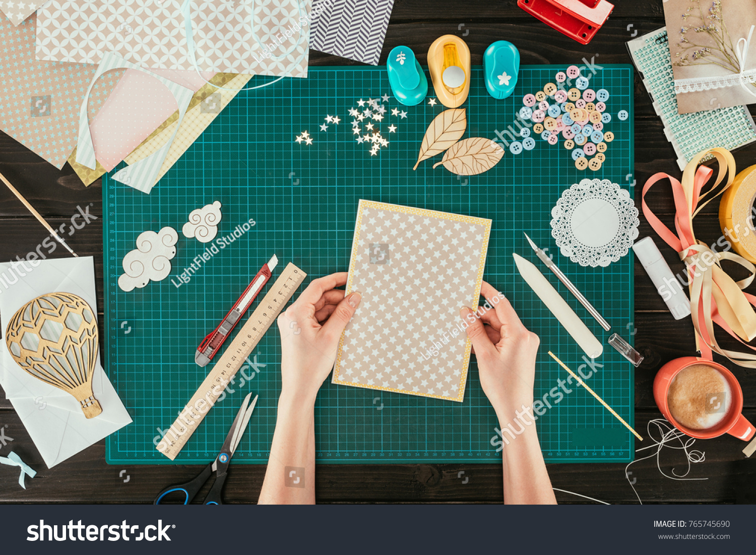 cropped image of designer holding template for scrapbooking postcard #765745690