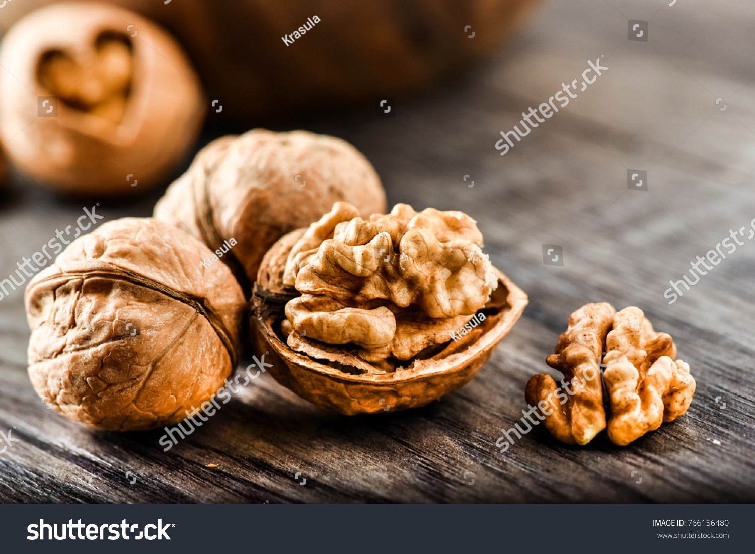 Walnuts on dark vintage table, Walnuts kernels in wooden bowl. Walnut healthy food #766156480