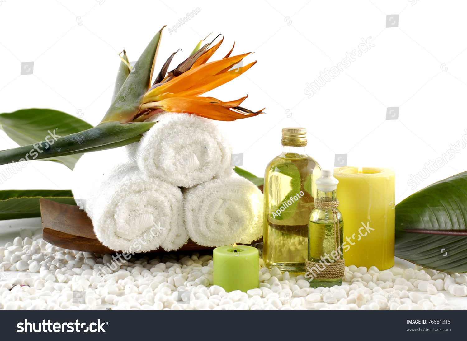 wooden bowl of towel and spring flower with massage oil on white pebble #76681315