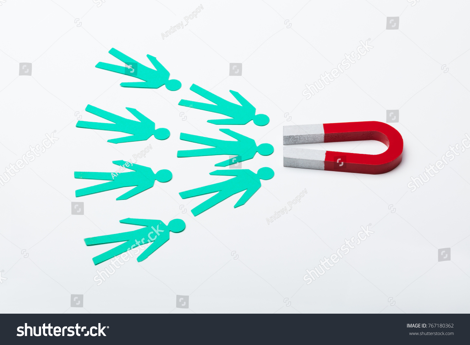 High Angle View Of A Red Horseshoe Magnet Attracting Paper Cut Out On White Background #767180362