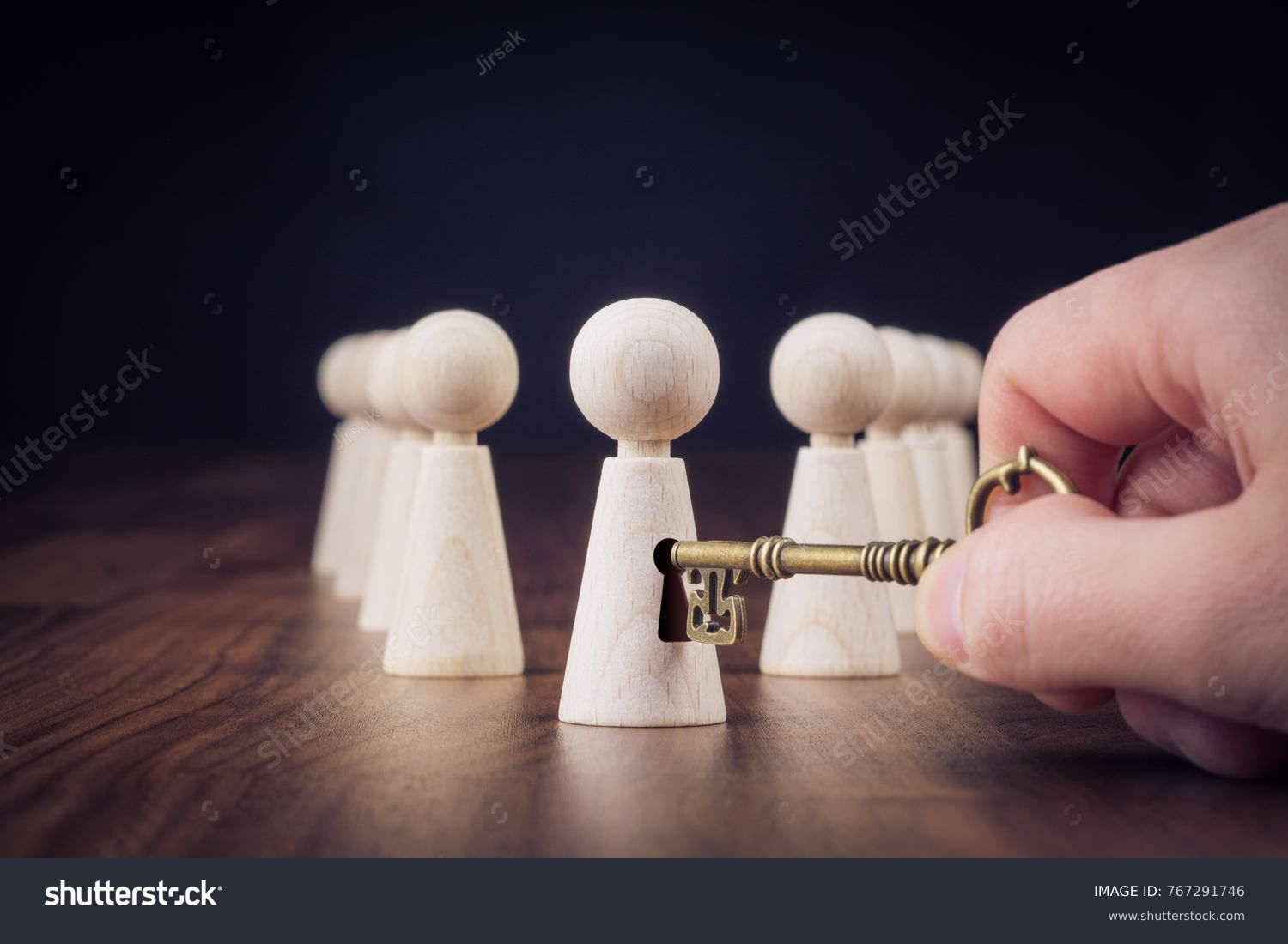 Unlock potential - motivational concept. Manager (HR specialist) unlock leader potential represented by figurine and hand with key. #767291746