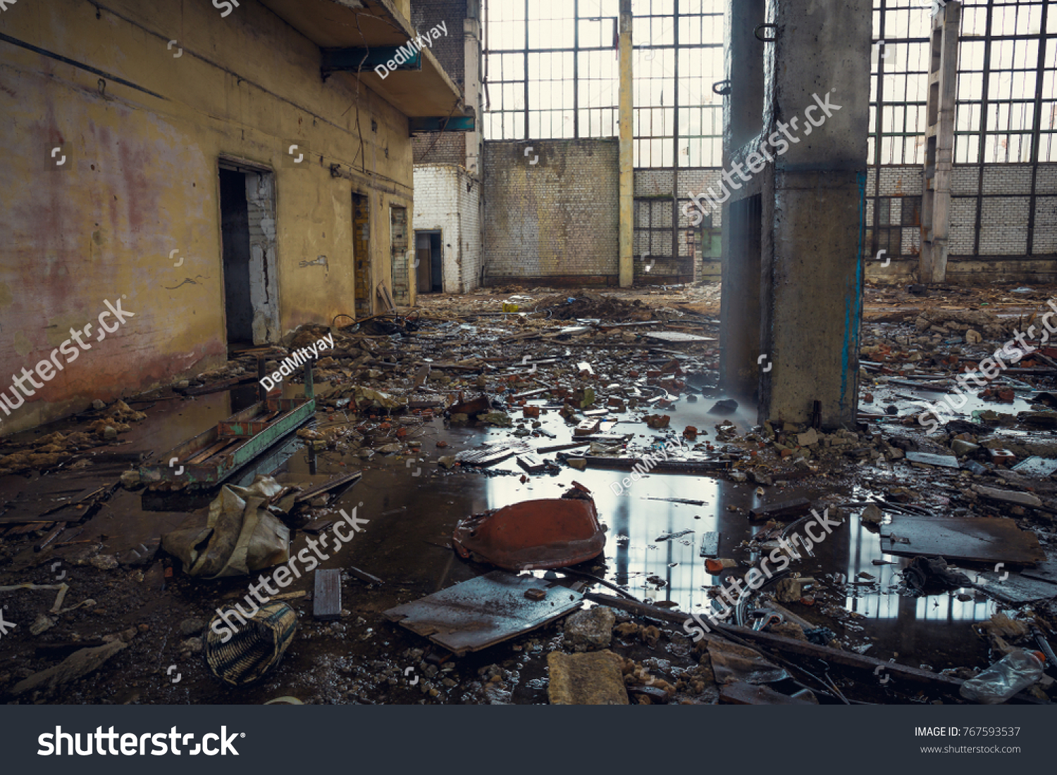 Ruined industrial building with puddles on the ground creepy abandoned warehouse, toned #767593537