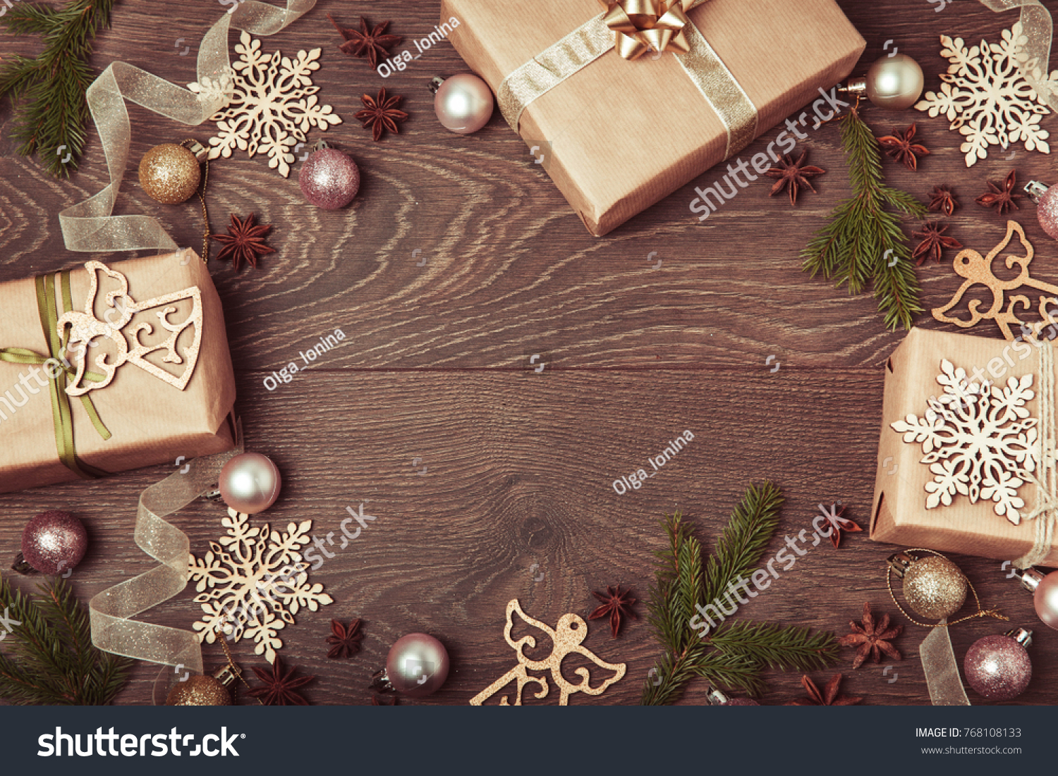 Christmas holiday composition, ornament. Festive creative gold pattern, spruce branches, xmas tree, xmas golden decor holiday ball with gift and ribbon on wooden brown background. Flat lay, top view #768108133
