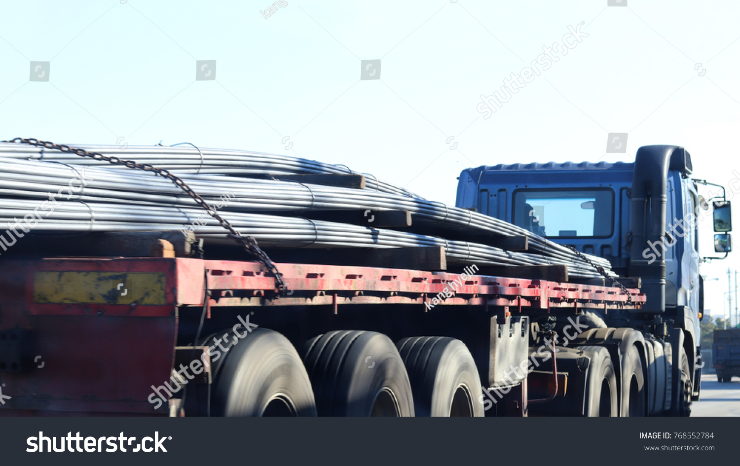 A truck that carries iron pipes. #768552784