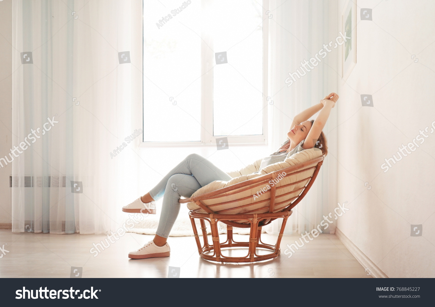 Happy young woman relaxing at home #768845227