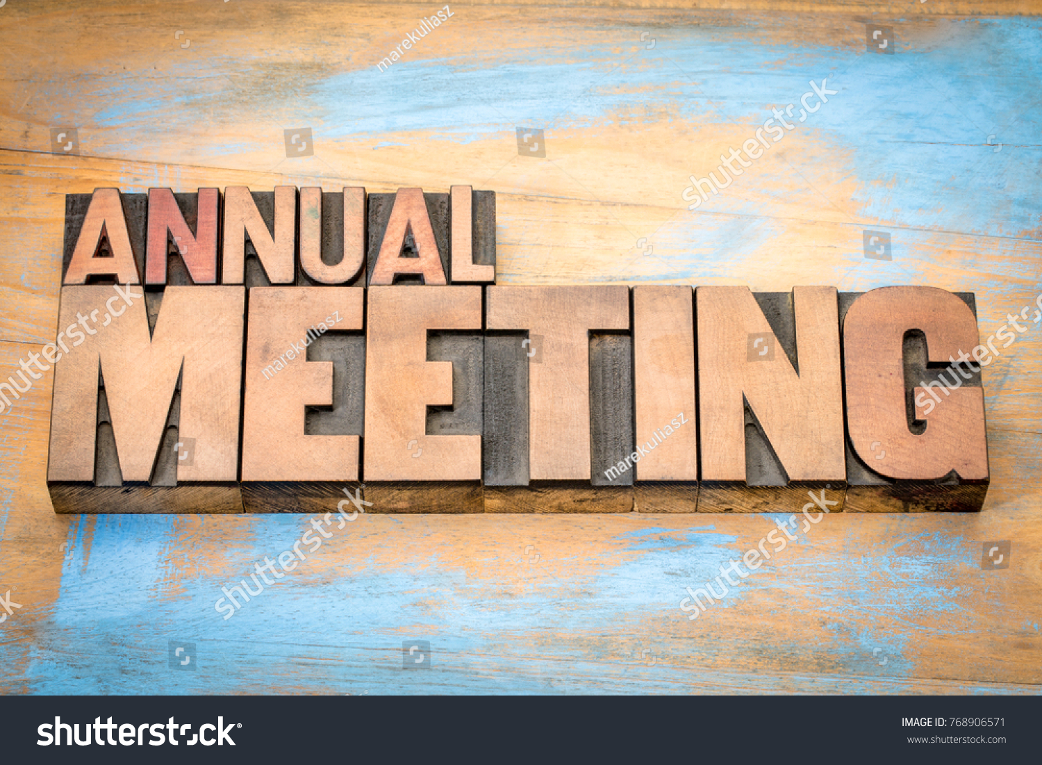 annual meeting word abstract in letterpress wood type against grunge wooden background #768906571