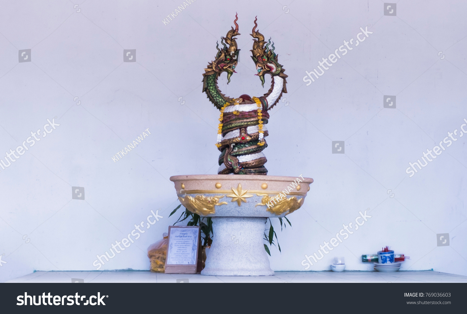 Two Naga statue in pot on the cement floor. white concrete background. #769036603
