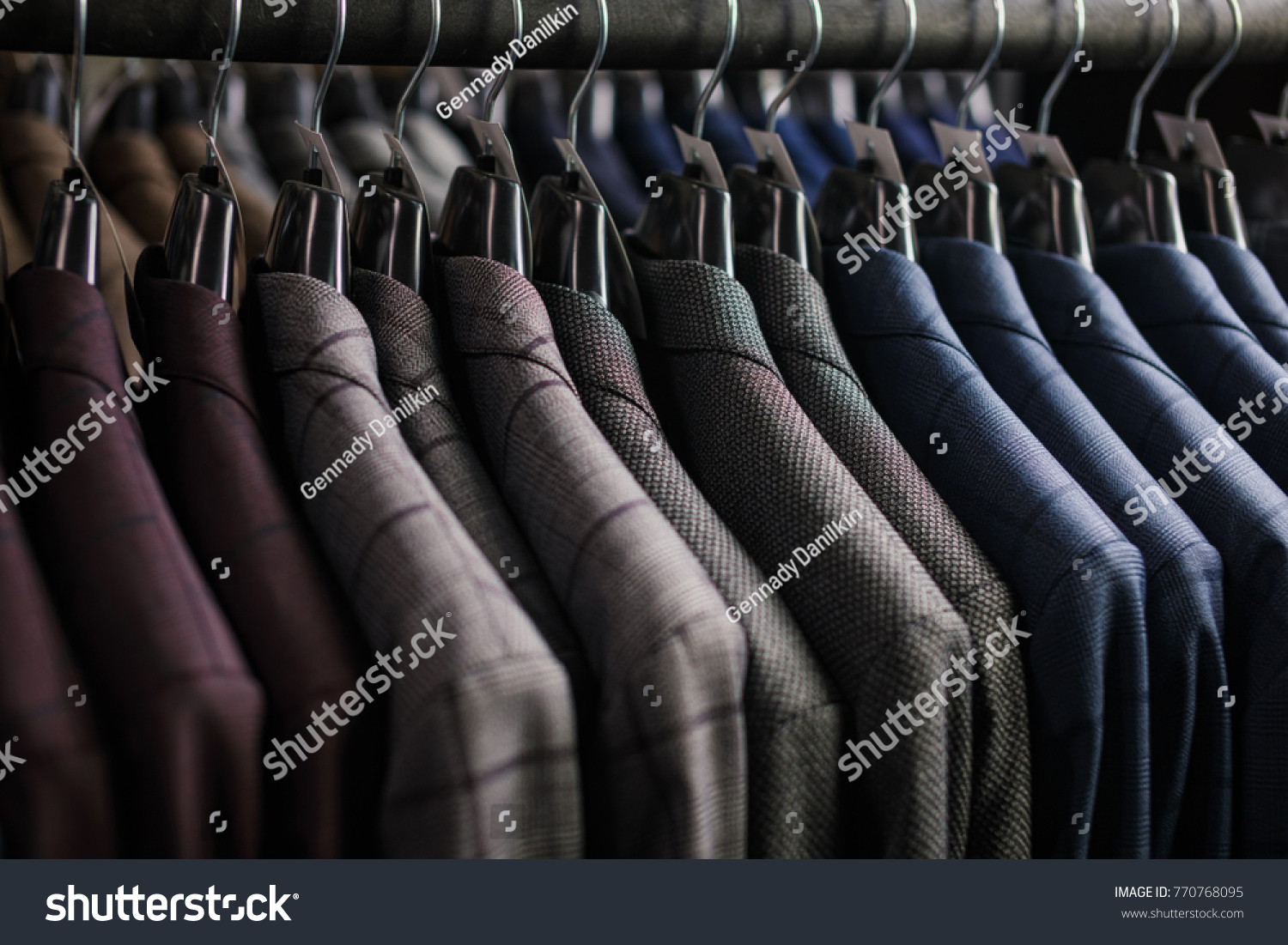 Row of men suit jackets on hangers #770768095