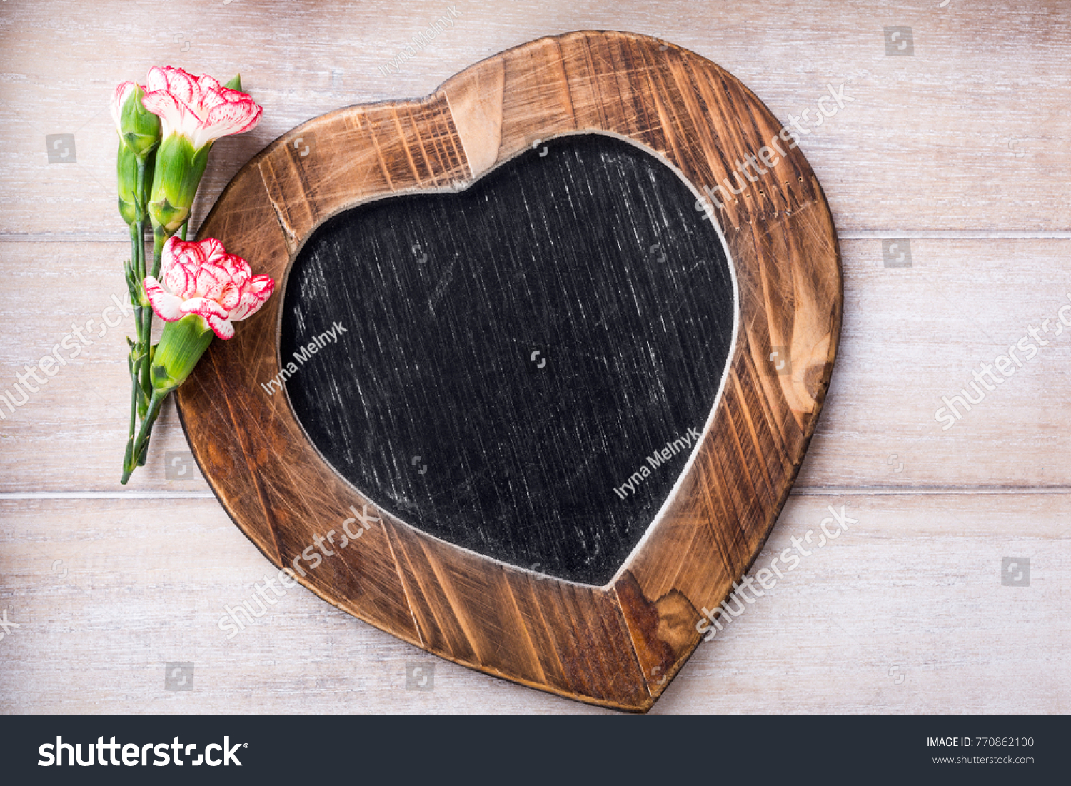 Valentines Day background with vintage slate chalk board in heart form and pink carnation flowers with copy space for text. View from above. #770862100