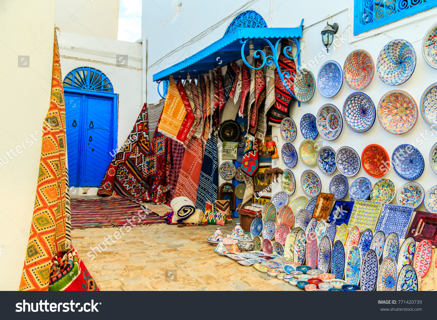 Souvenir earthenware and carpets in tunisian market, Sidi Bou Said, Tunisia. #771420739