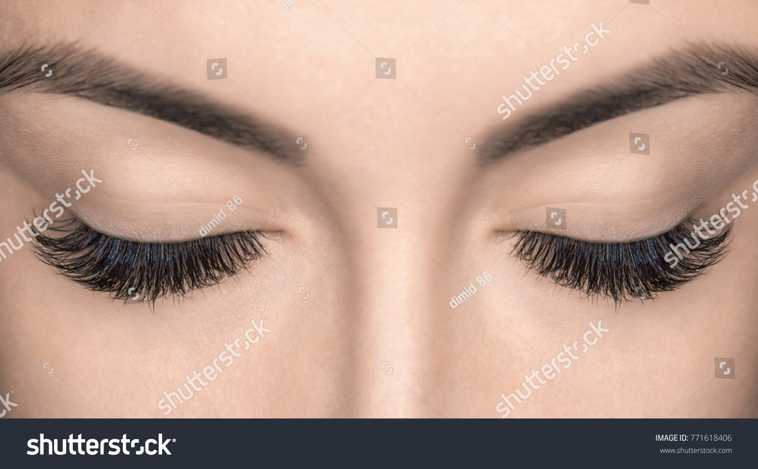Eyelash extension procedure. Beautiful Woman with long lashes in a beauty salon.  #771618406