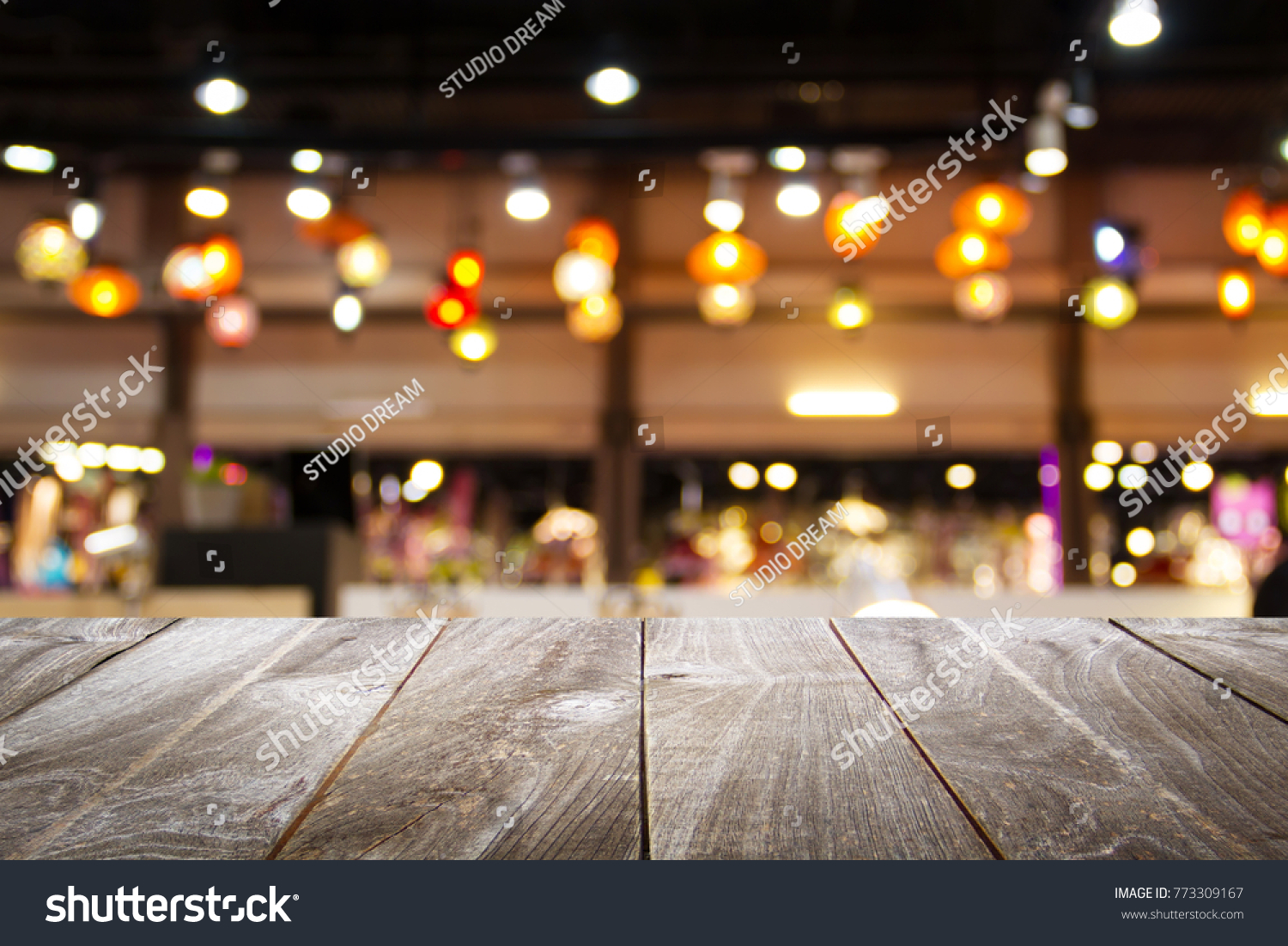 wooden table for placing products with a beautiful night restaurant backdrop, Space for placing items on the table, product and food display. #773309167