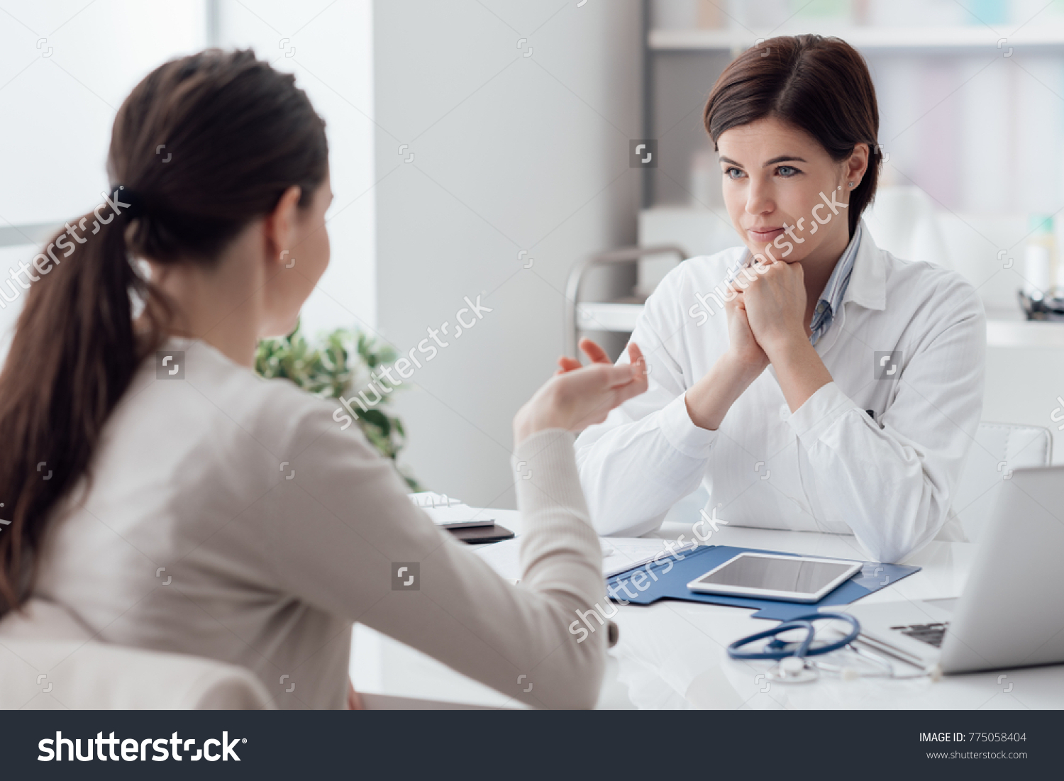 Doctor working in the office and listening to the patient, she is explaining her symptoms, healtcare and assistance concept #775058404