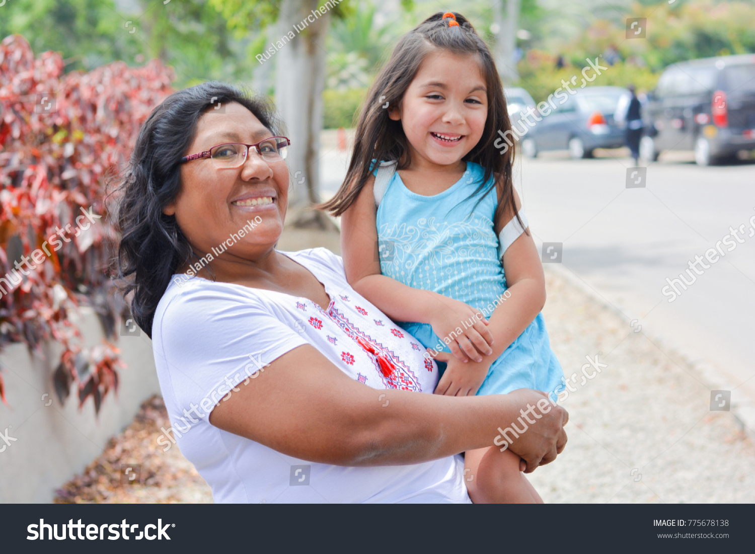 Happy latin mom and little daughter outside.  #775678138
