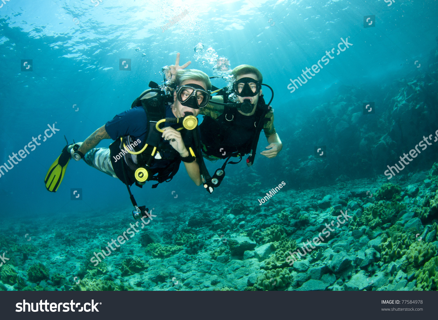 scuba divers enjoy a scuba dive #77584978