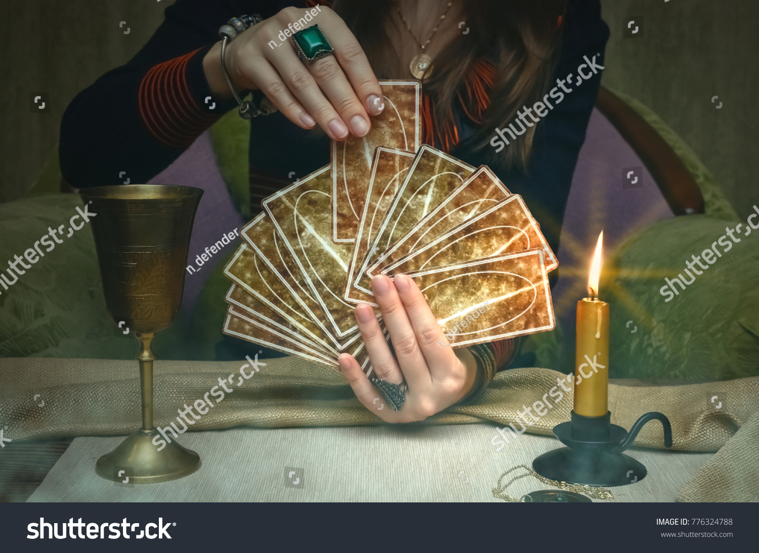 Tarot cards on fortune teller desk table. Future reading. Woman fortune teller holding and hands a deck of tarot cards. #776324788