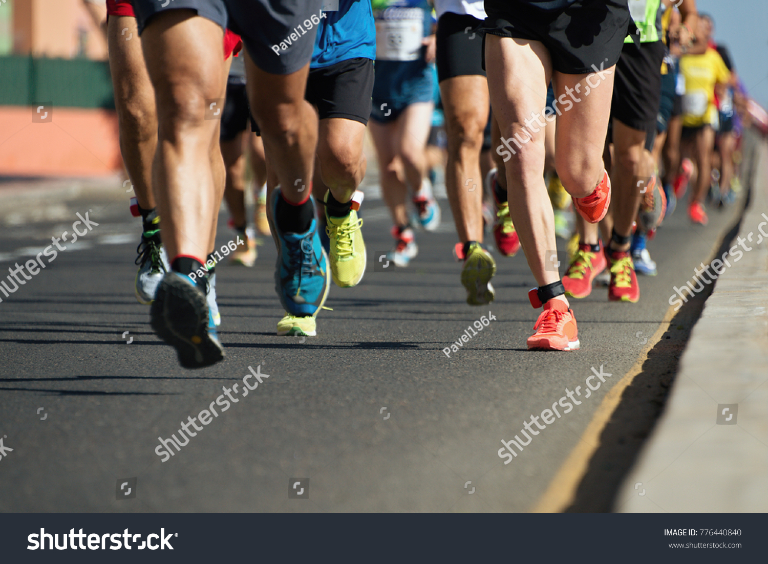 Marathon running in the light of evening,running on city road detail on legs #776440840