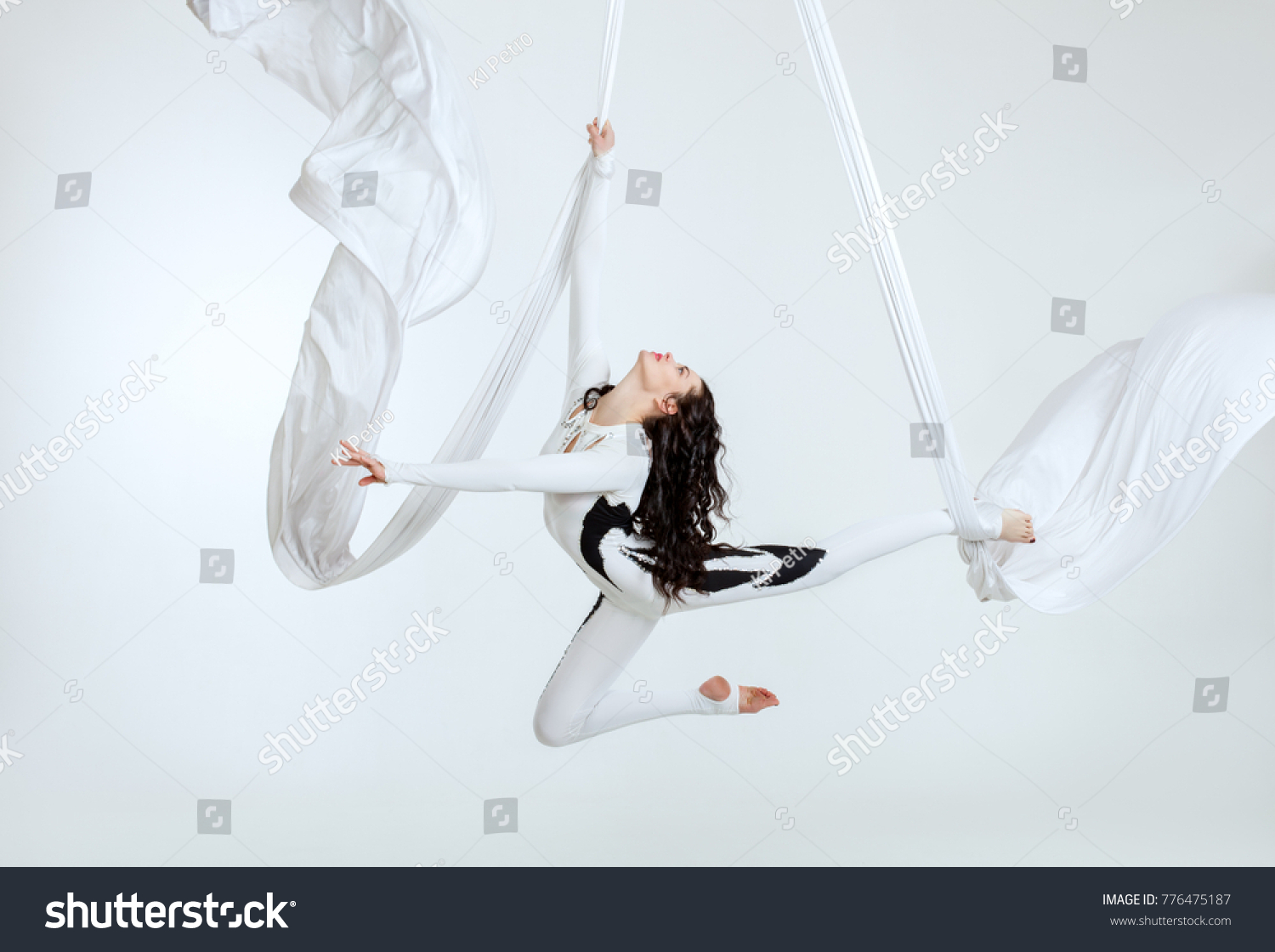 Aerial artistic acrobatics, a woman demonstrates poses. #776475187