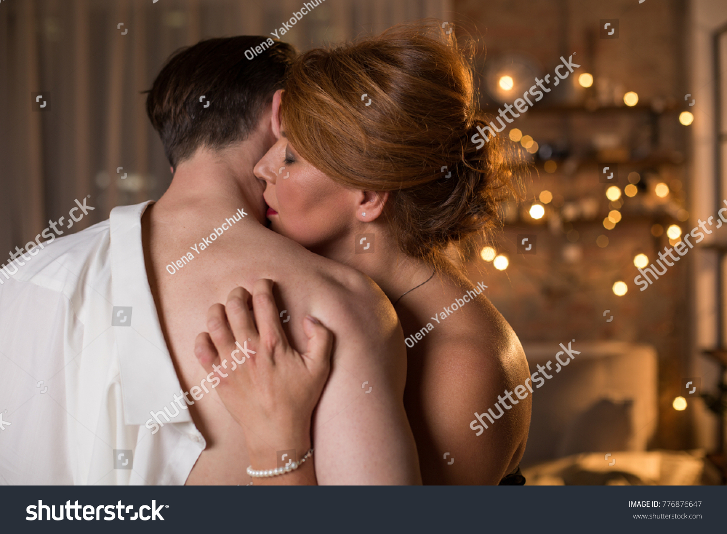 Affectionate loving couple is embracing with desire. Woman is kissing male neck with temptation while nailing into man nude back. Prelude concept #776876647