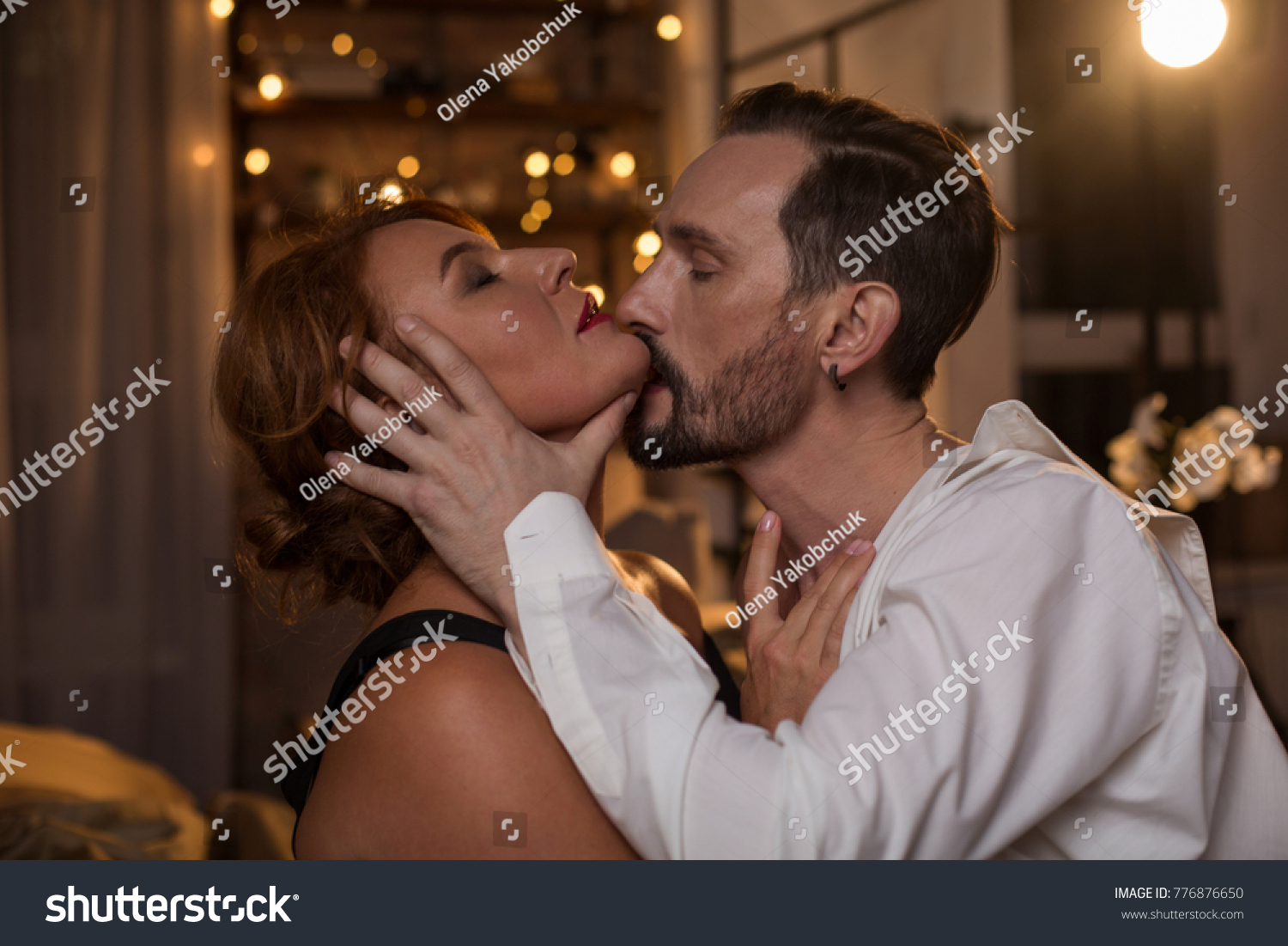 Profile of passionate bearded man kissing woman with desire while touching her face gently. Female eyes are closed with pleasure. Closeness concept #776876650