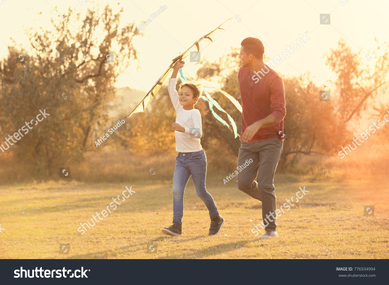 Father and his son with kite in countryside #776934994