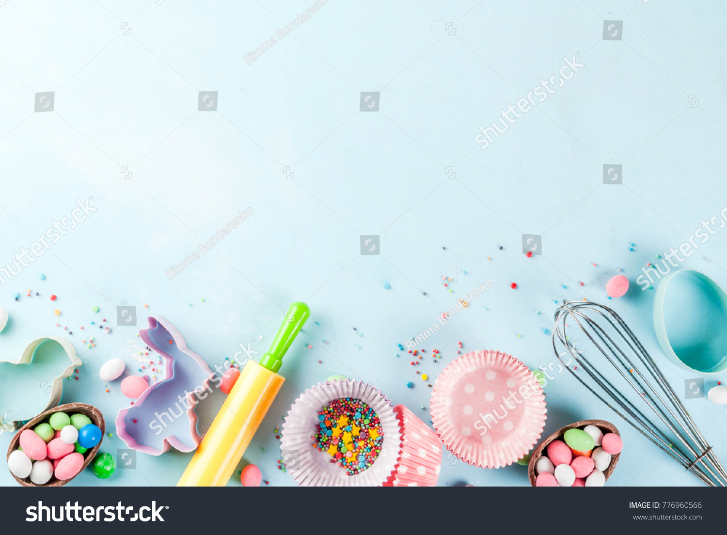 Sweet baking concept for Easter,  cooking background with baking - with a rolling pin, whisk for whipping, cookie cutters, sugar sprinkling, flour. Light blue background, top view copy space #776960566