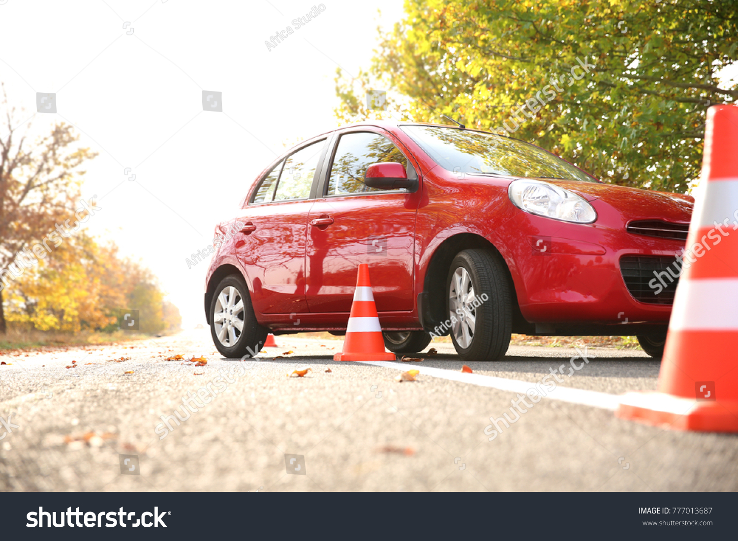 Beautiful red car and safety cones in driving school #777013687