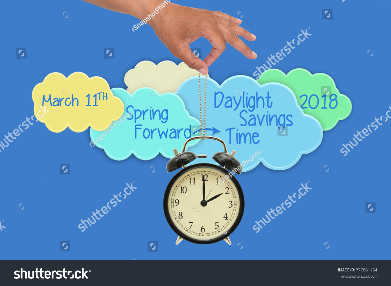 Spring Forward Daylight Savings Time March 11 2018 Clouds Hand dangling 2 o'clock alarm clock blue background #777861154