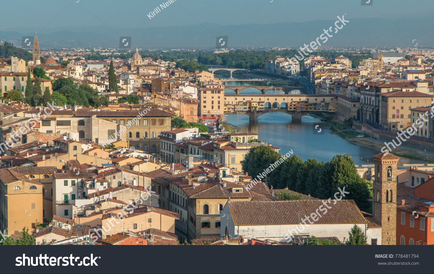 Top view of Florence city timelapse at sunrise with arno river bridges and historical buildings, mountains on background. Green trees, blue cloudy sky at summer day #778481794