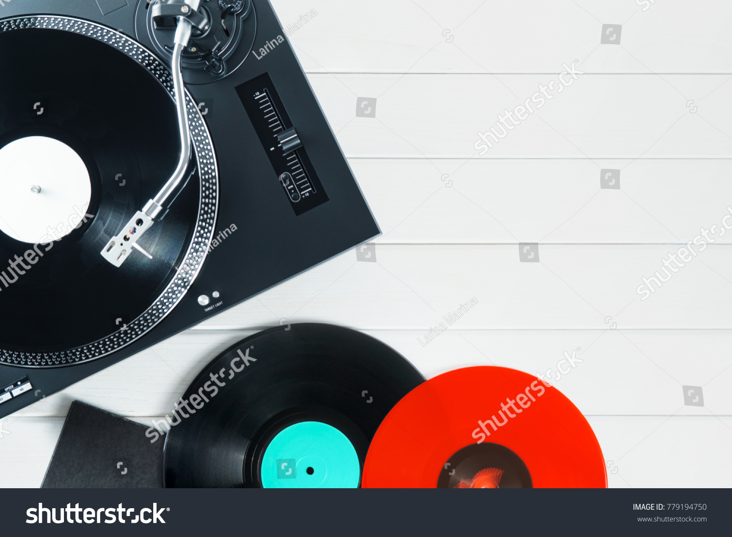 Turntable vinyl record player  with vinyl records and headphones on a wooden table. Sound technology for DJ to mix & play music. Black vinyl record. Vinyl record player     #779194750