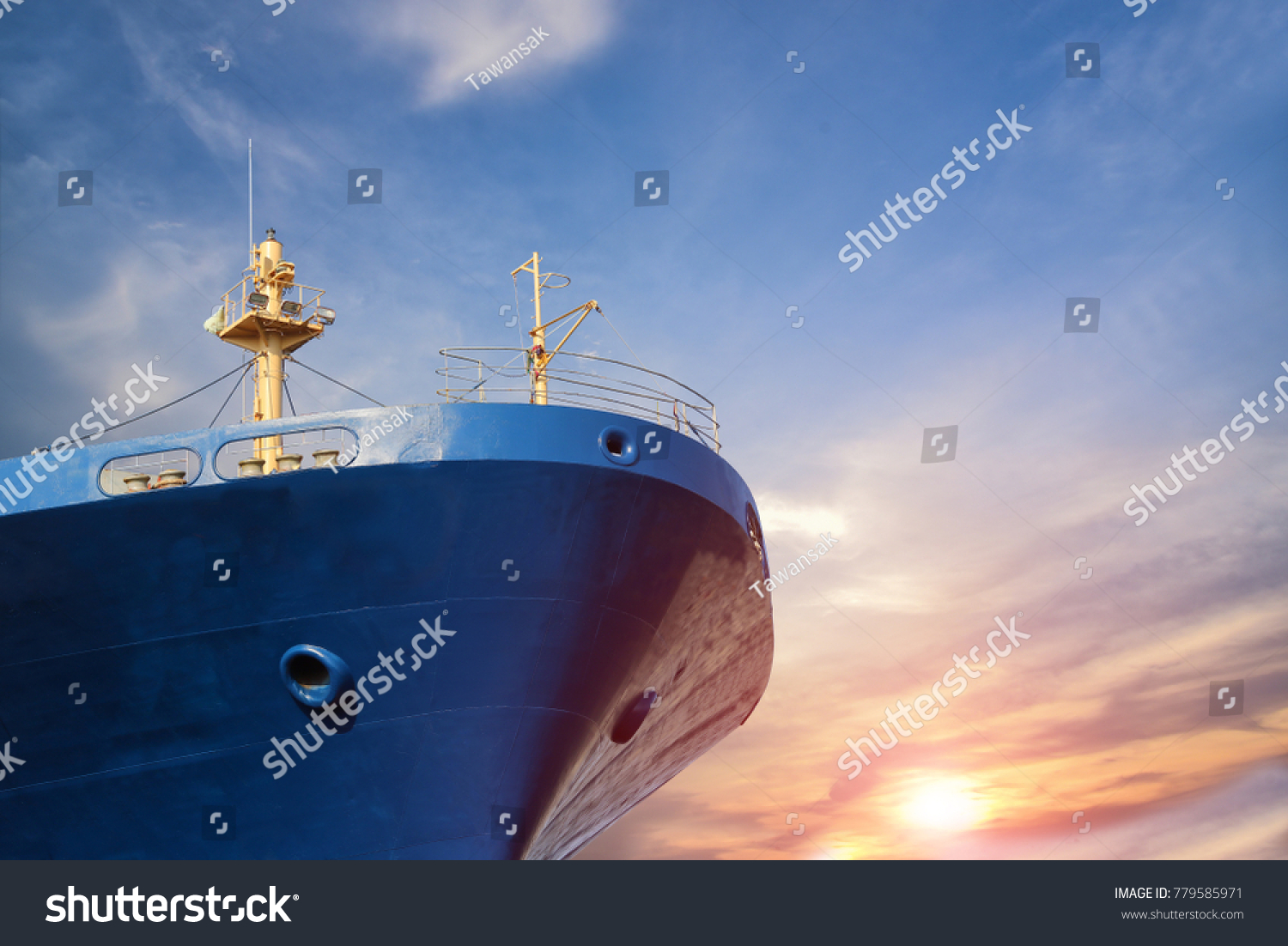 cargo ship forward close up on blue sky background #779585971