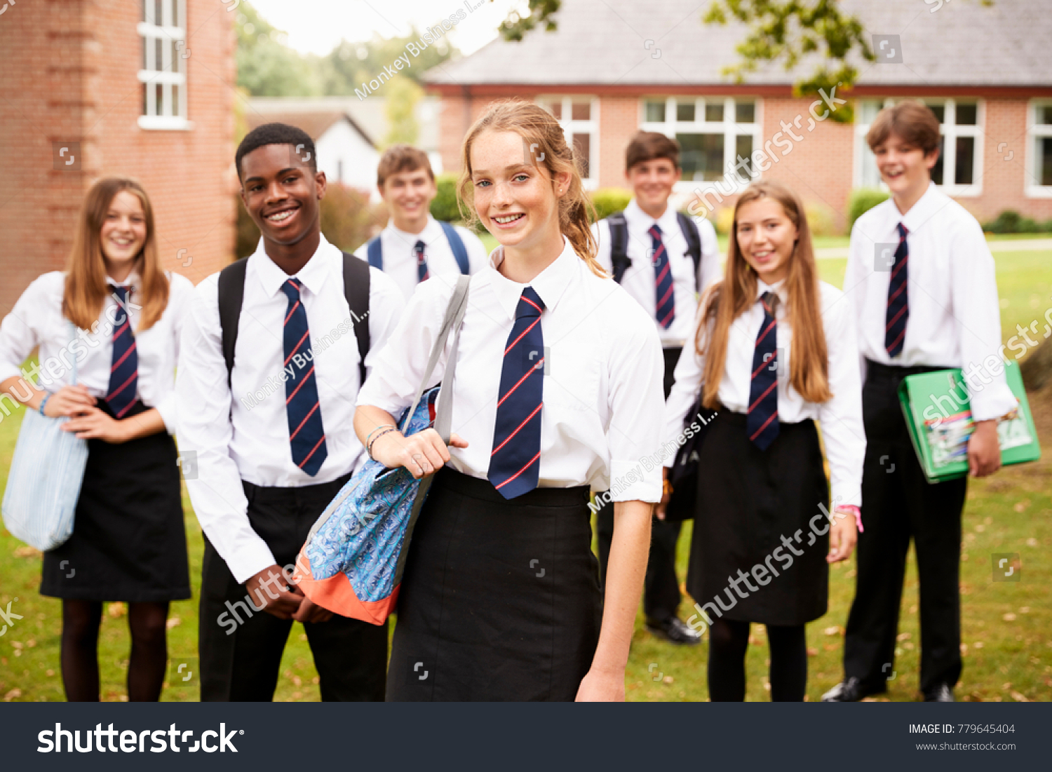 Portrait Of Teenage Students In Uniform Outside School Buildings #779645404