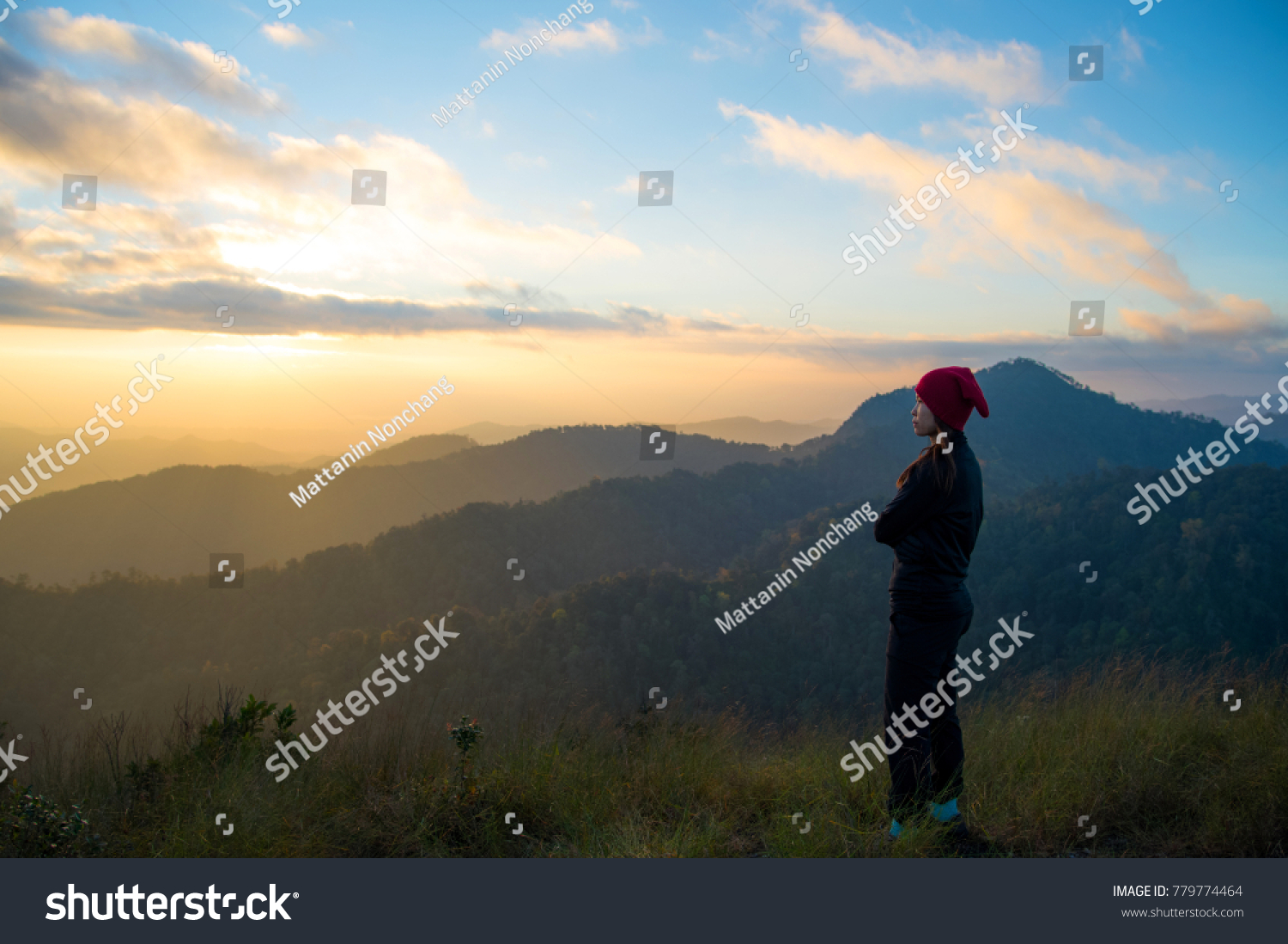 Woman tourism hiking vacation and travel. Tourist woman in camping site standing and enjoying mountains landscape view of sunset, sunrise at winter mountain in Chiangmai, Thailand. #779774464