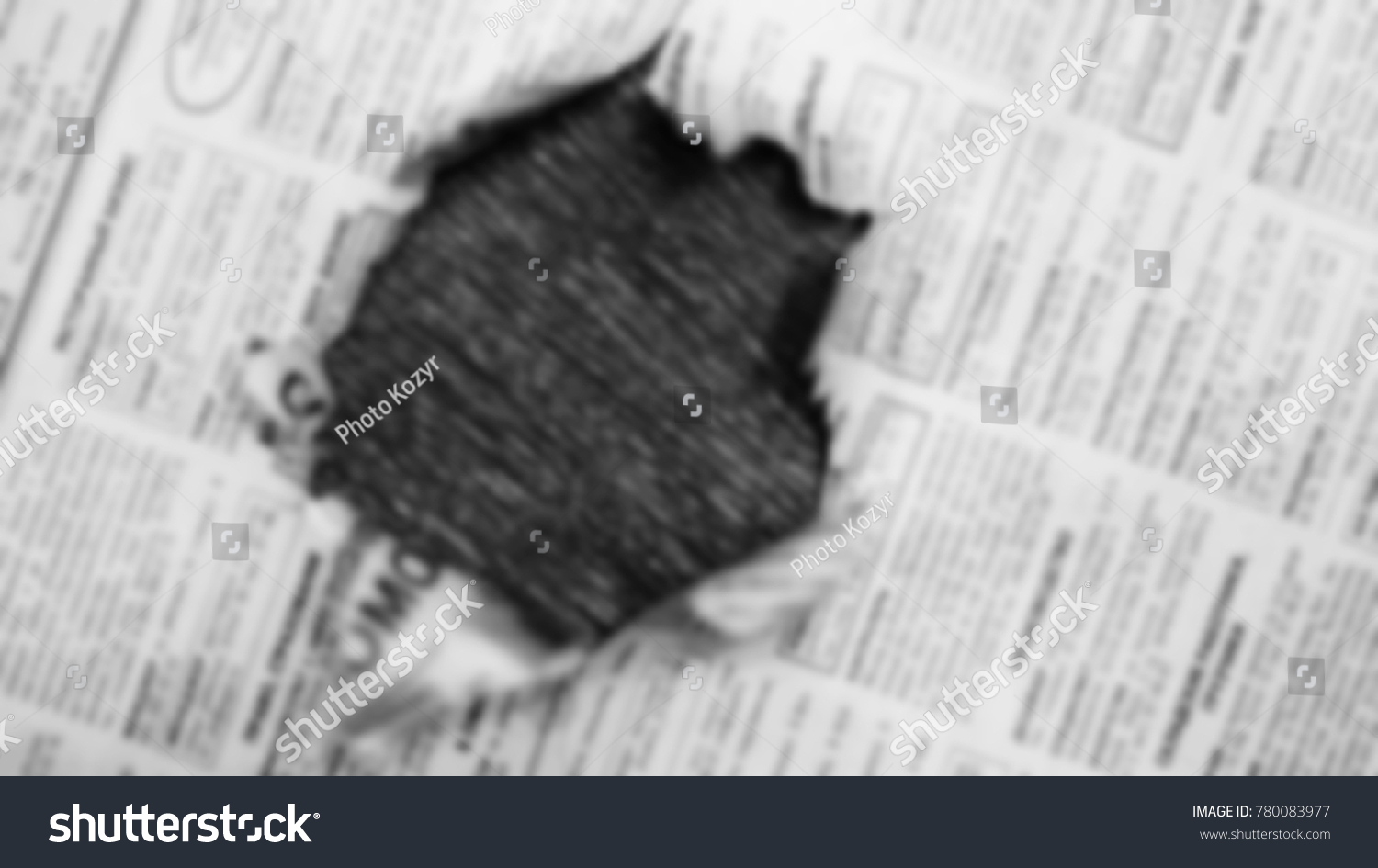 Newspaper page with hole in the middle. Daily paper with news, articles, headlines, photos and text is ripped. Old journal texture for background, blurred #780083977