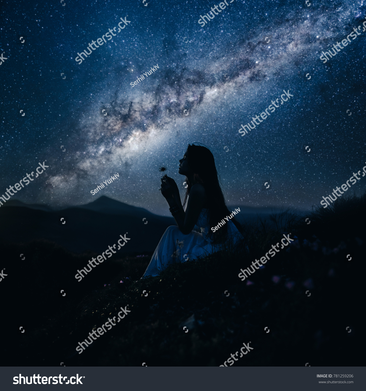 Woman looking at beautiful milky way. Beautiful woman in a long white dress in the mountains. Girl sitting on a rock. Milky Way at mountains. Night colorful landscape. Starry sky with hills at summer #781259206