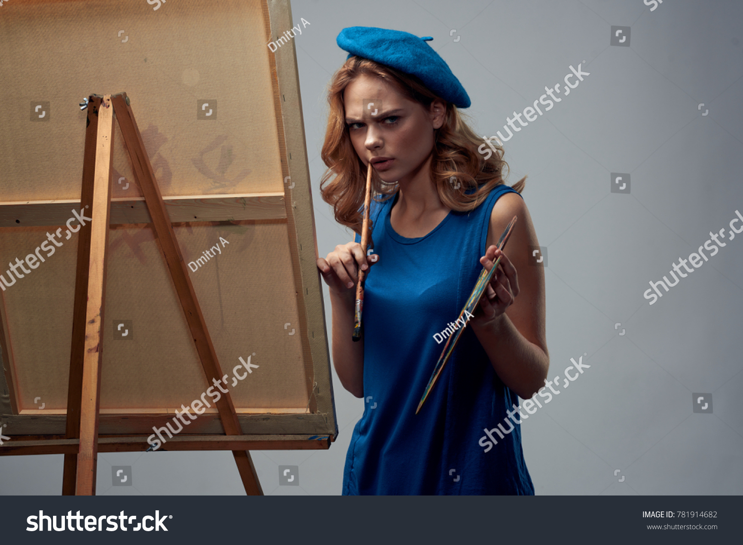 painter draws on a gray background, draw, art, drawing, paint, easel with a canvas #781914682