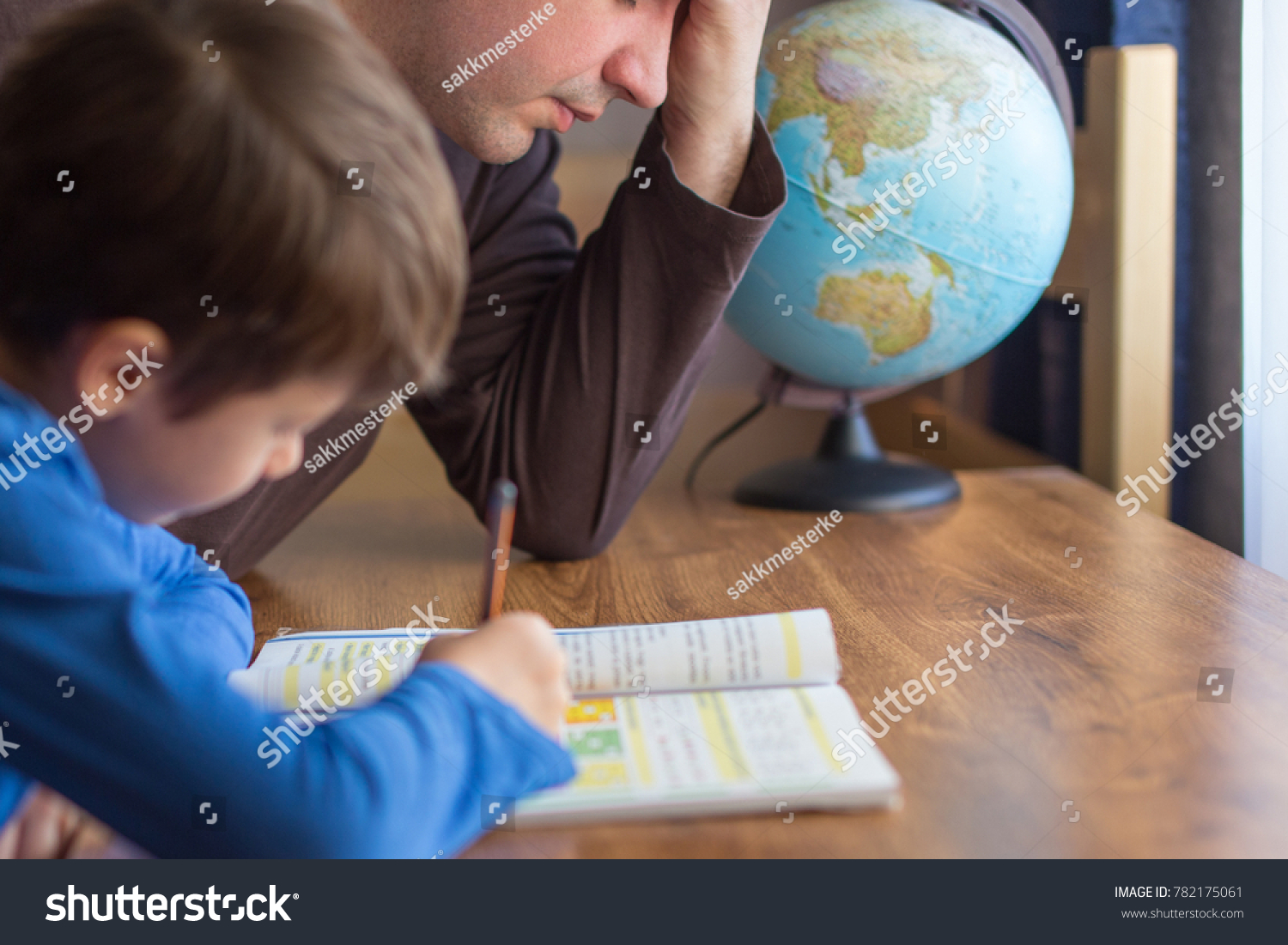 Sad father tired about helping little son in mathematics homework #782175061