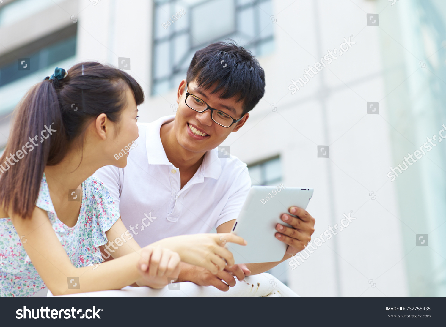 happy young asian or Chinese people using tablet outdoor #782755435