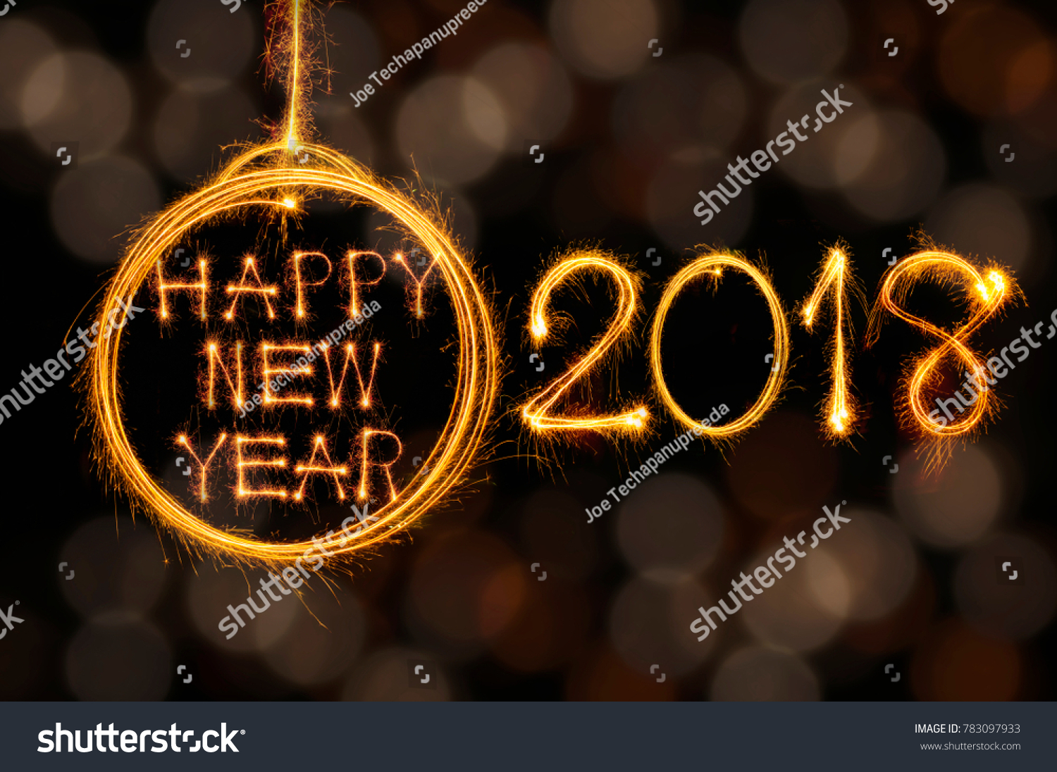 Hang Happy new year text in ball and 2018 written with sparkle fireworks on gold bokeh background #783097933