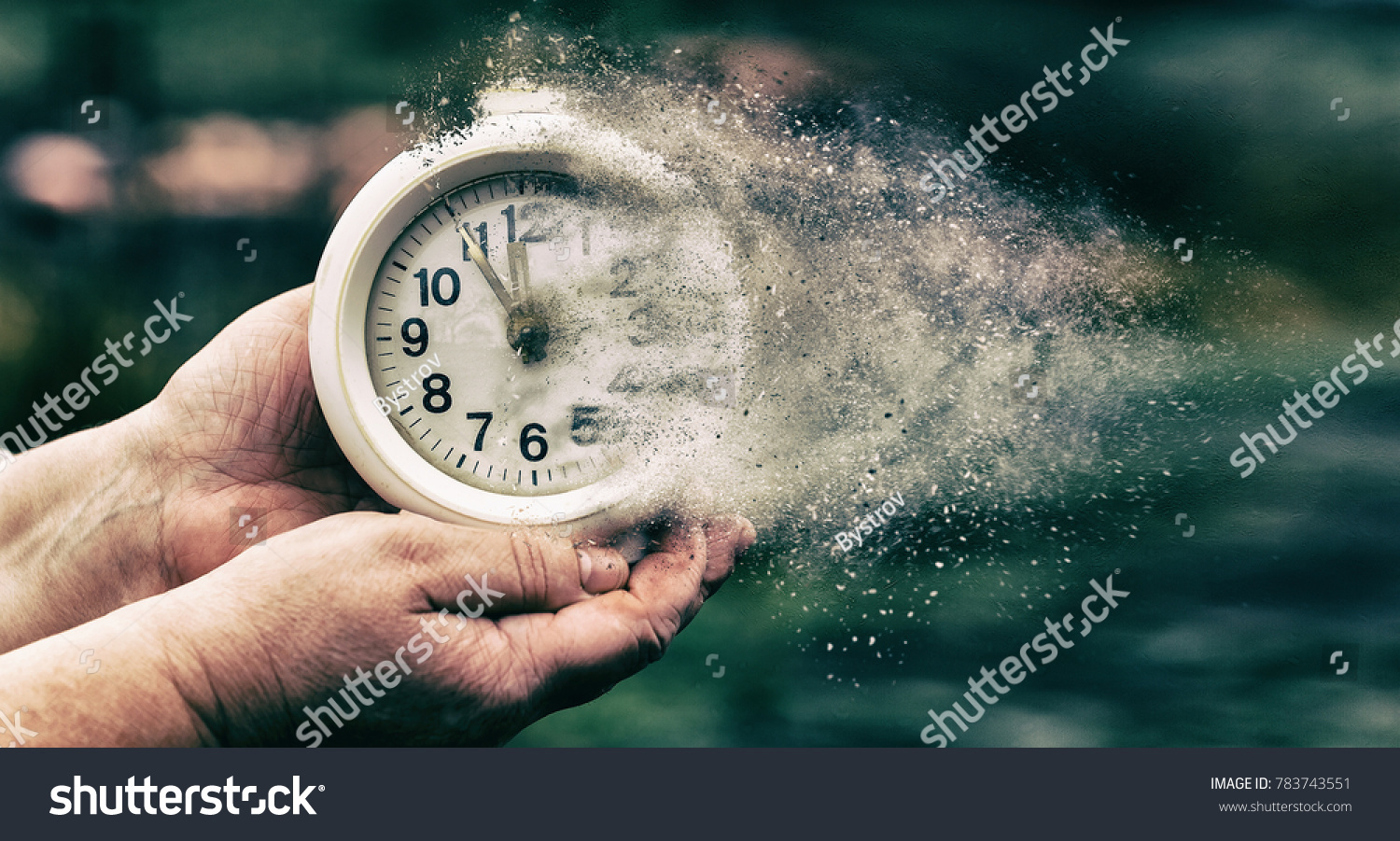 Retro alarm clock or vintage alarm clock in old hand. Time is running out concept shows clock that is dissolving away into little particles #783743551