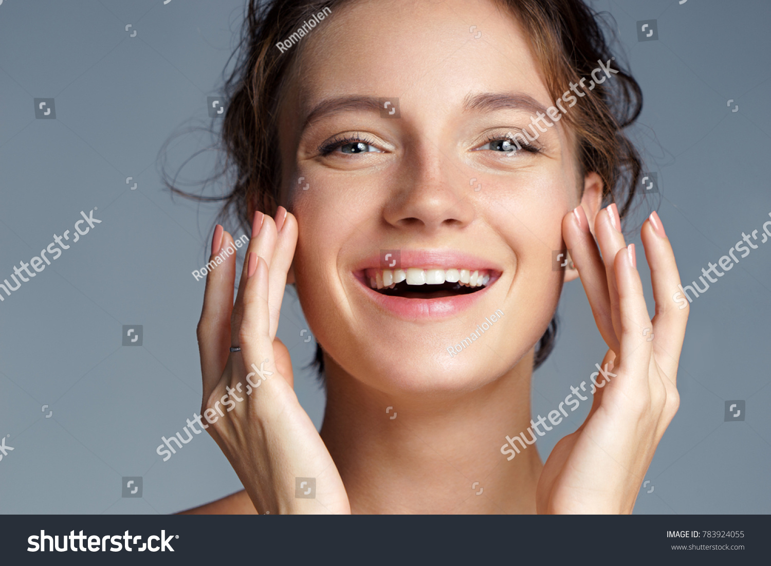 Image with beautiful brunette girl touching her face on grey background. Close up. Beauty & Skin care concept #783924055