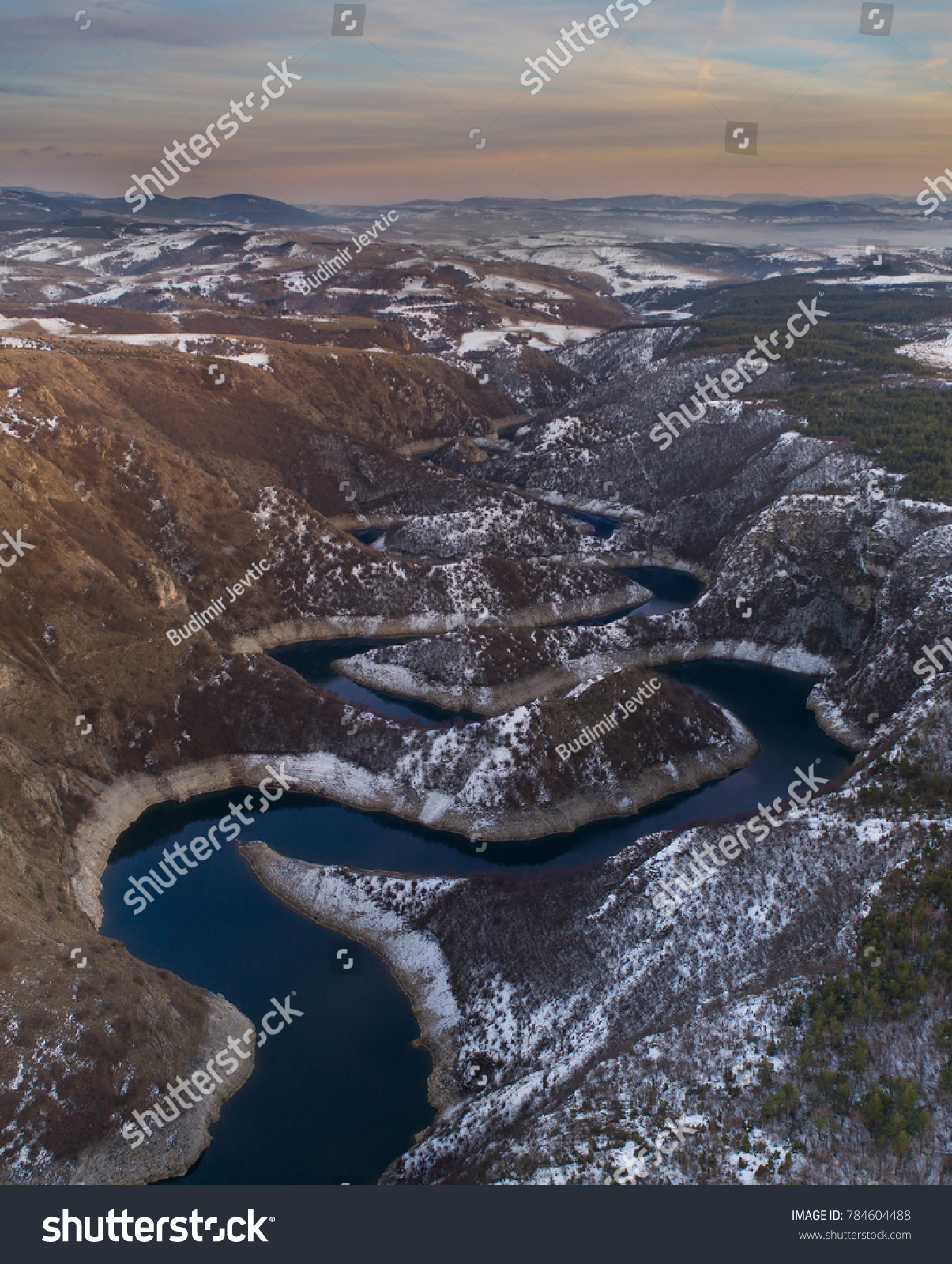 Aerial image of Uvac river forming meanders in mountain canyon in winter time in Serbia #784604488