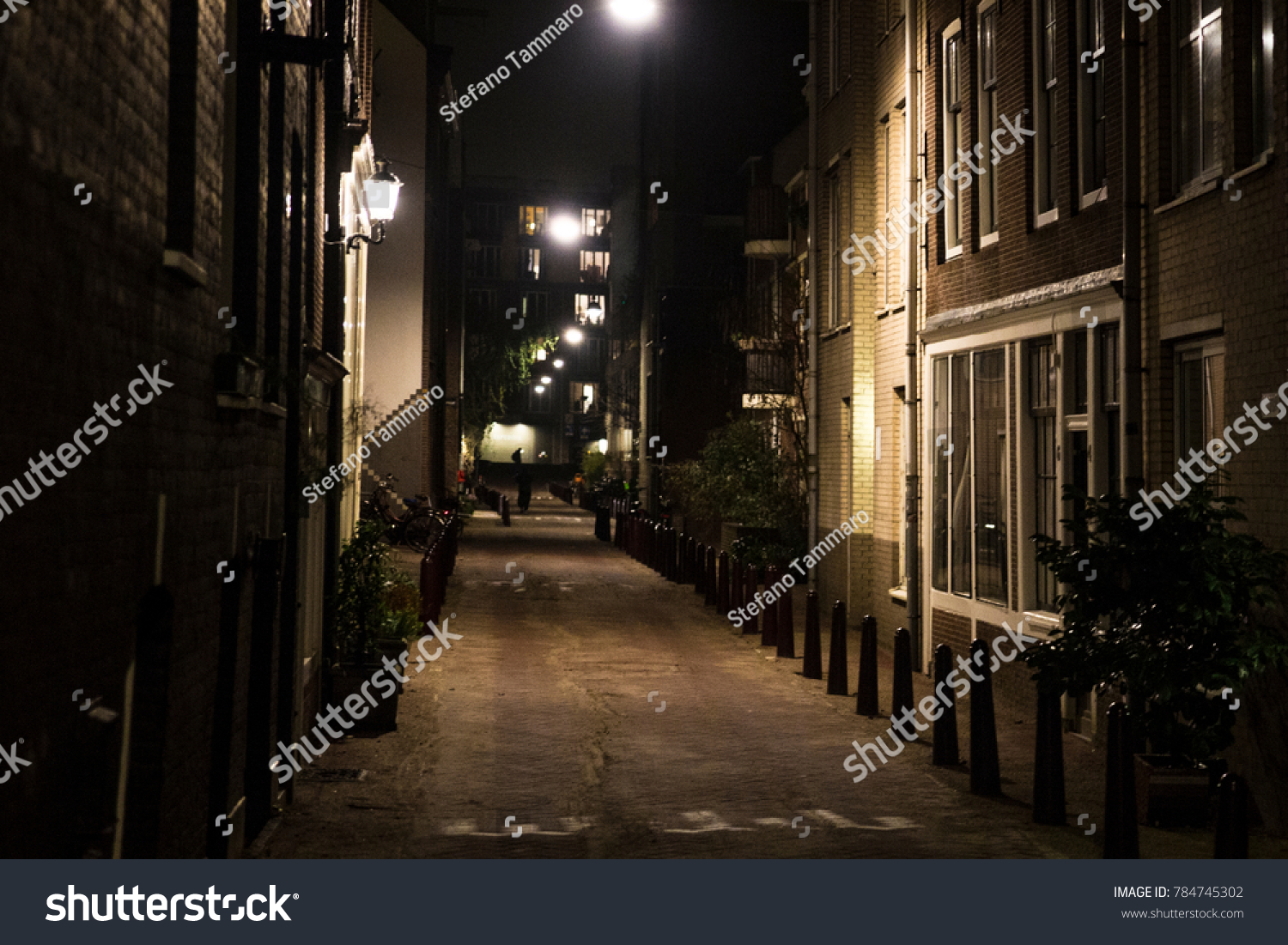 Night view of a small, narrow street in the center of Amsterdam, Holland. #784745302