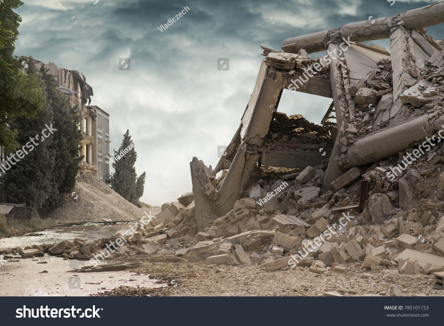 View on a collapsed concrete industrial building with dark dramatic sky above. Damaged house. #785101153