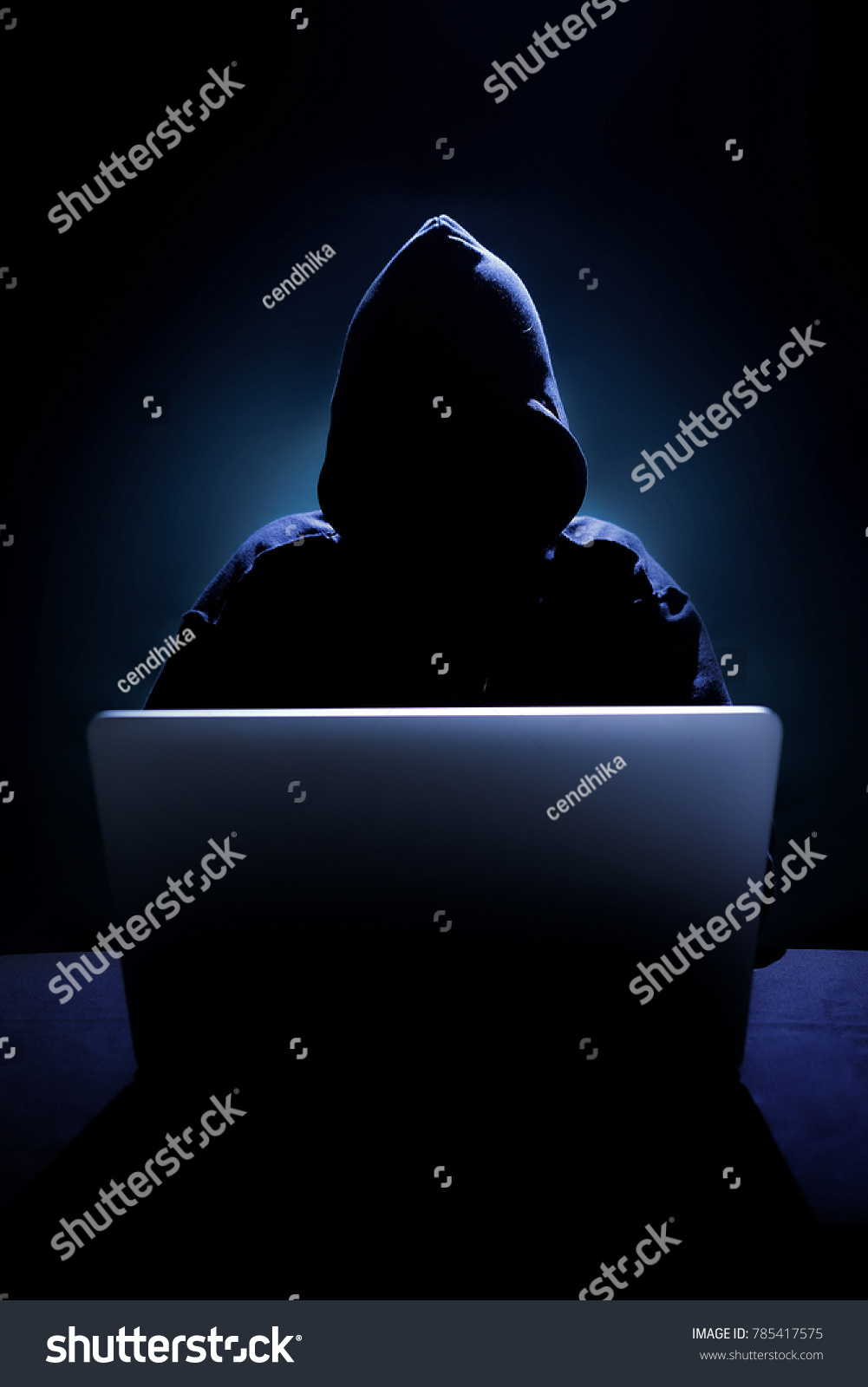 Hacker in front of his computer. Dark face #785417575