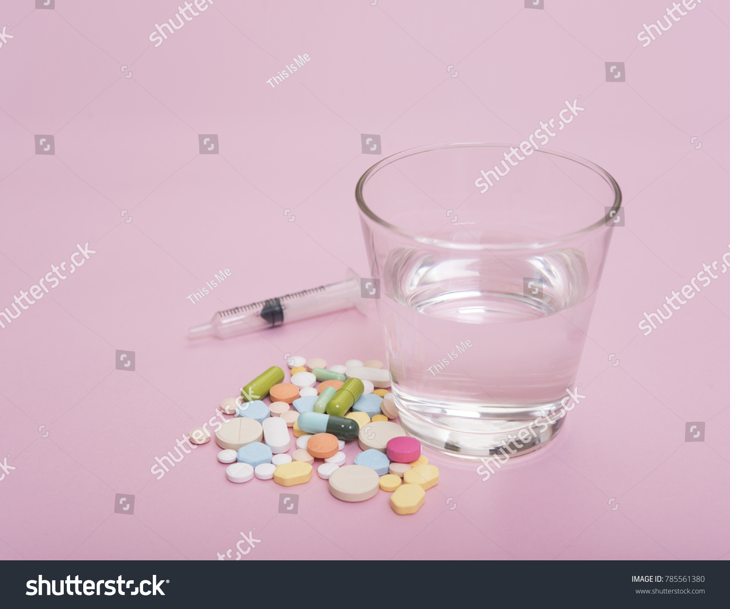 colorful medicine and glass of water on pink background. #785561380
