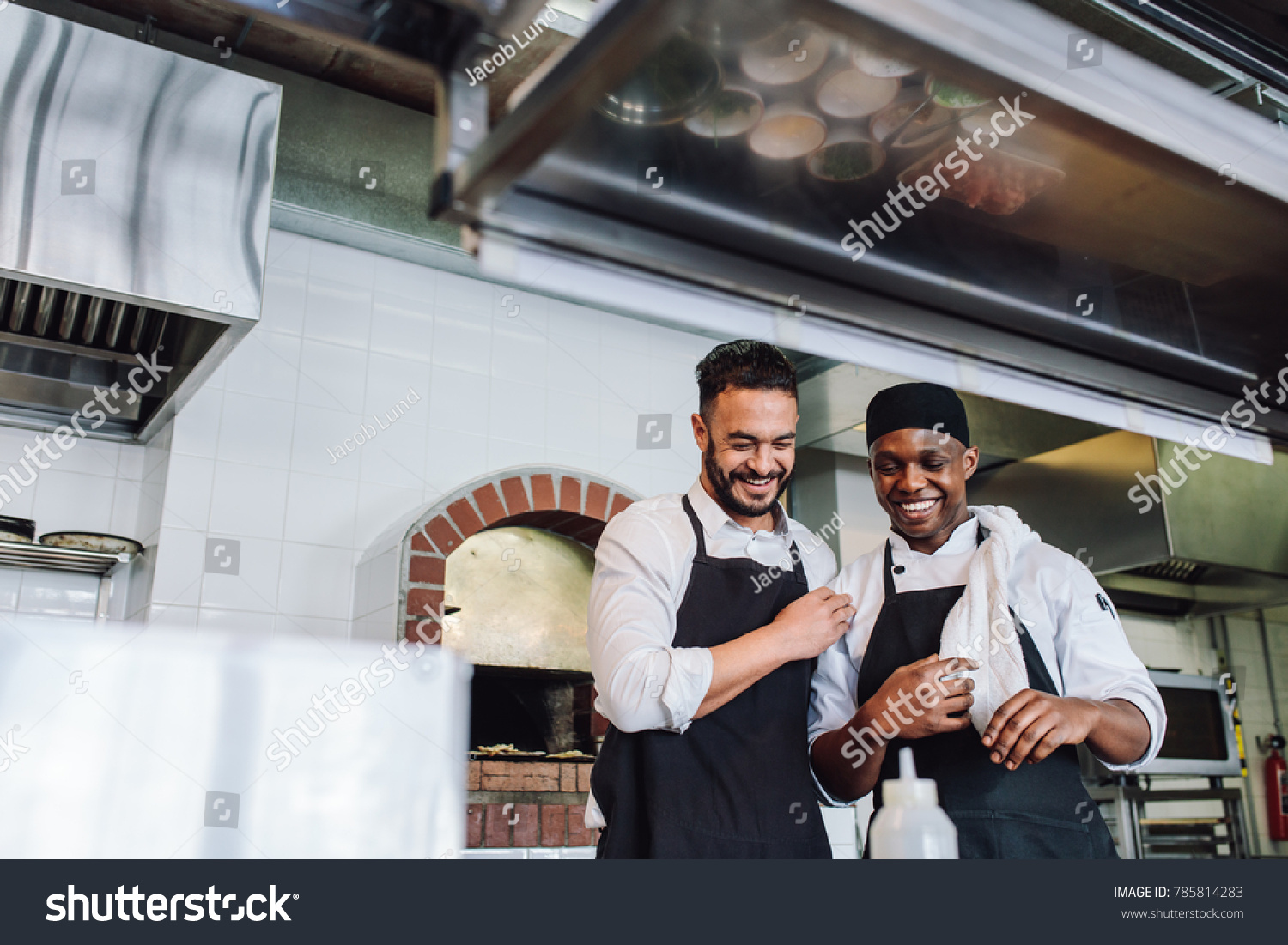 Smiling professional chefs working in restaurant - Royalty Free Stock ...