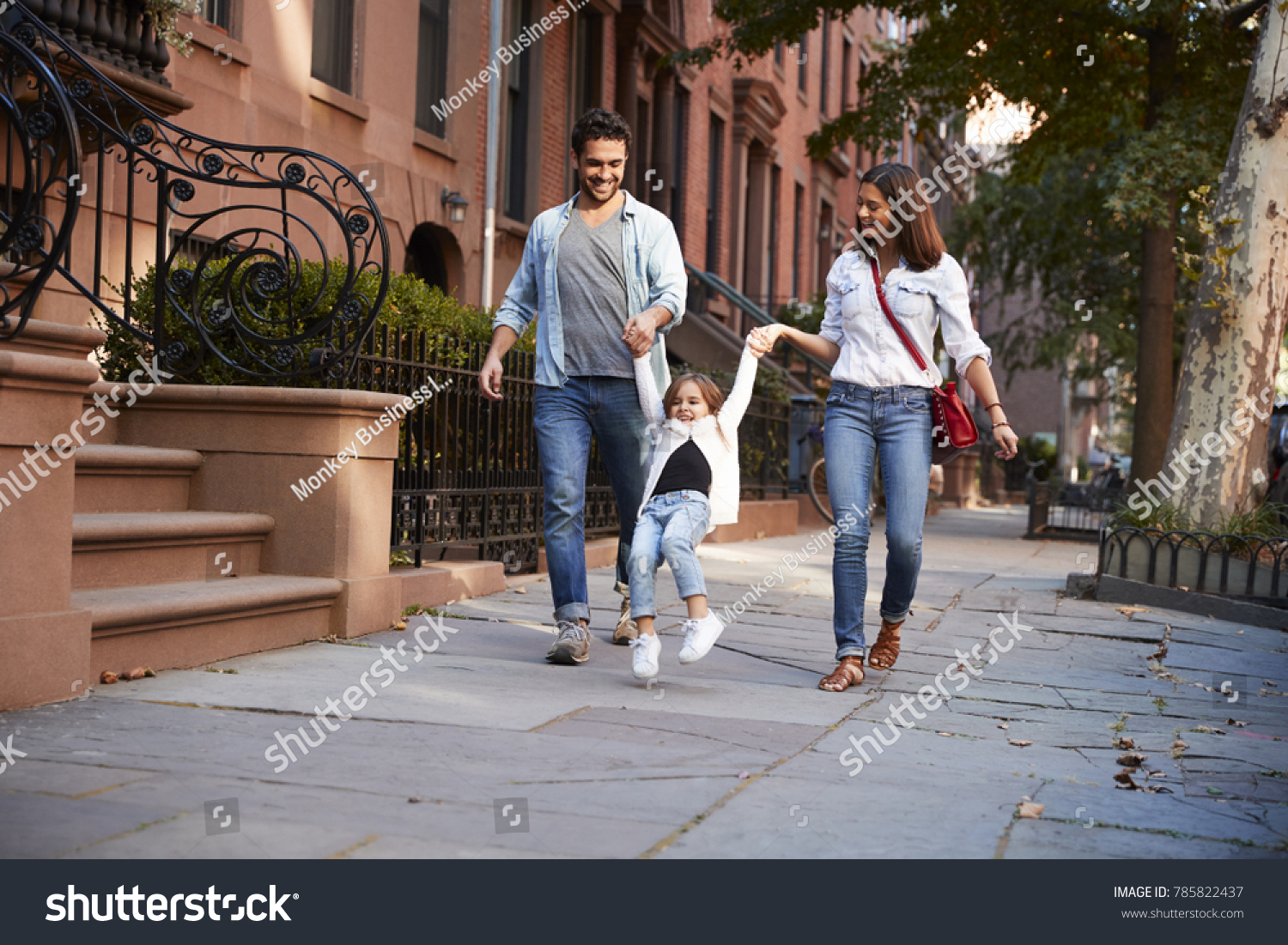 Family taking a walk down the street #785822437