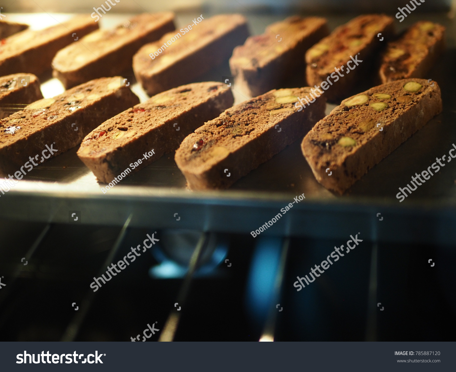 Baking chocolate pistachio biscotti for holiday desserts idea and great for dipping in coffee! (close up, selective focus, blurred space for text) #785887120
