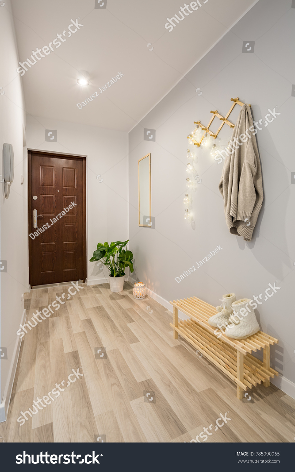 Simple entryway with wooden floor panels and shoe bench #785990965